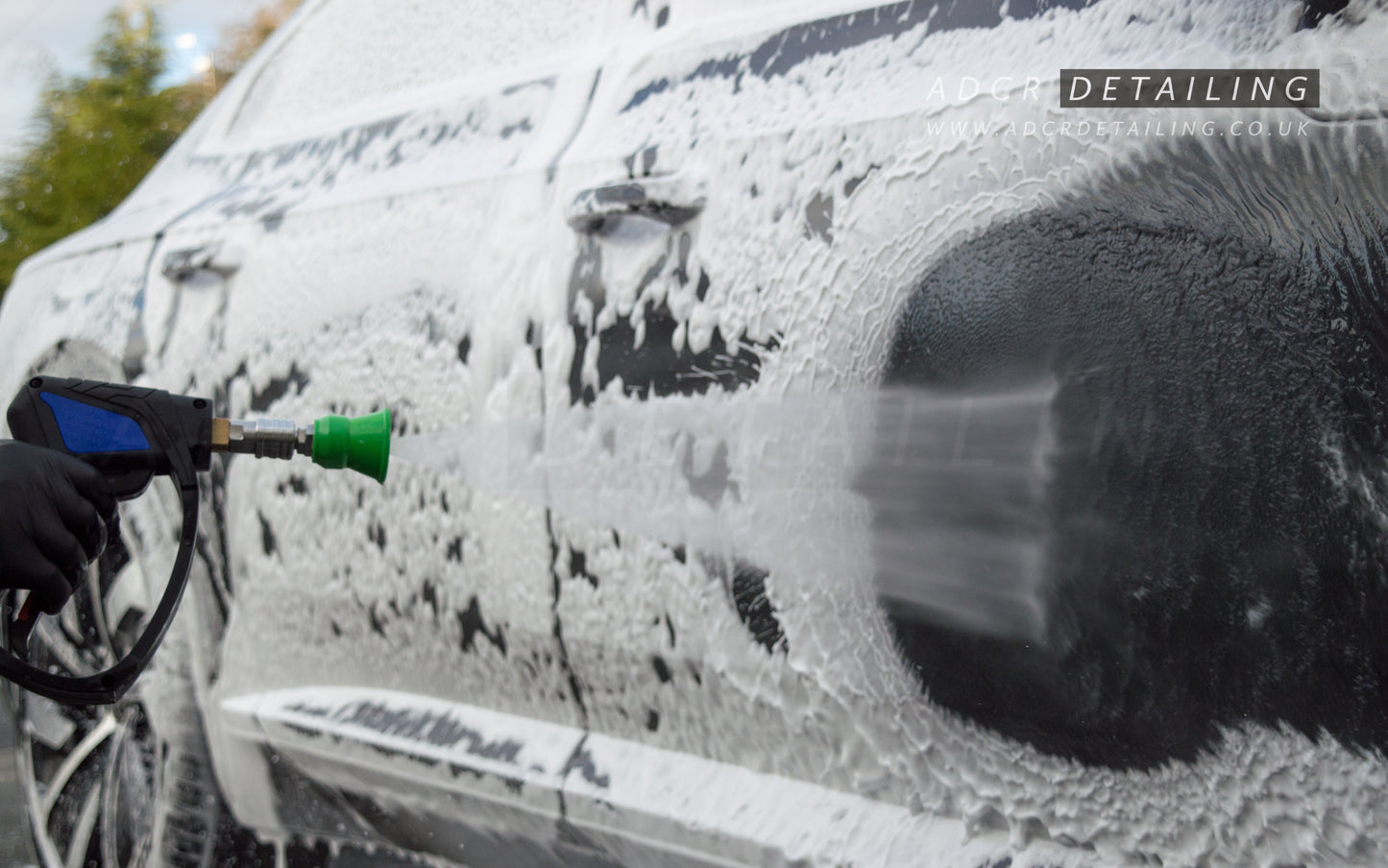 1/4in Premium Quick Release Pressure Washer Detailing Nozzle rinsing snow foam off a car.
