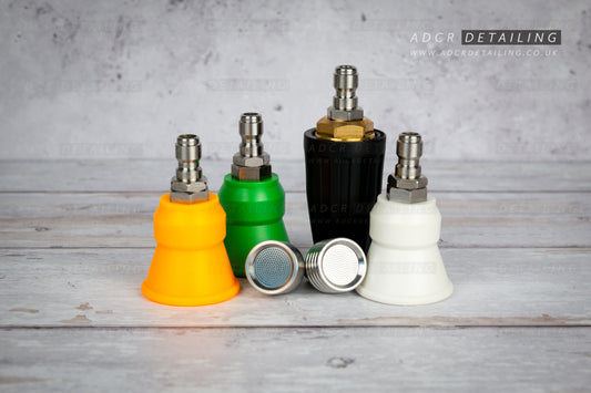 Collection of car detailing nozzles in various colours on a grey surface with 'ADCR Detailing' branding. Premium 1/4in Quick Release Nozzle Bundle. Shower Nozzles, 40 degree, 15 degree, 25 degree and turbo jet nozzle.