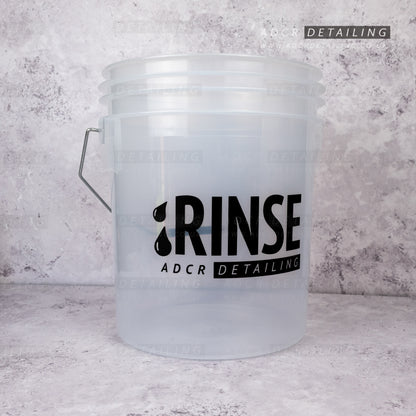 Clear 16L detailing and valeting bucket with 'RINSE' and 'ADCR Detailing' text on a textured gray background