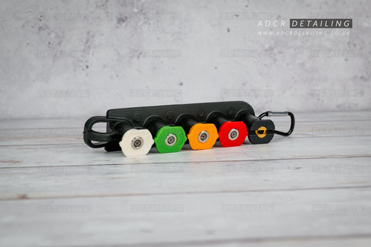1/4in Quick Release Pressure Washer Nozzles in a black holder on a grey surface, featuring ADCR Detailing branding.