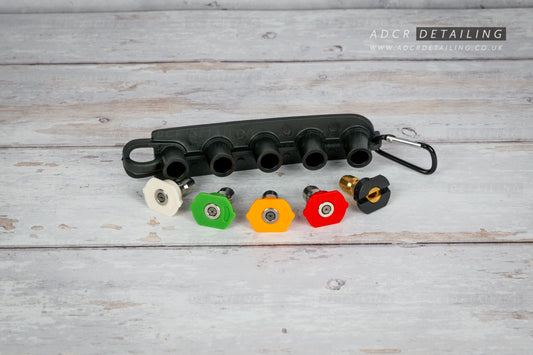 1/4in Quick Release Pressure Washer Nozzles with a black holder on a grey surface, featuring ADCR Detailing branding.