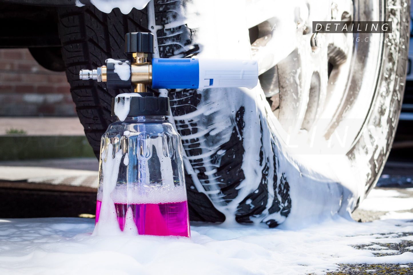 ADCR Detailing Snow Foam Cannon V2 in Snow Foam Puddle, next to a car wheel.