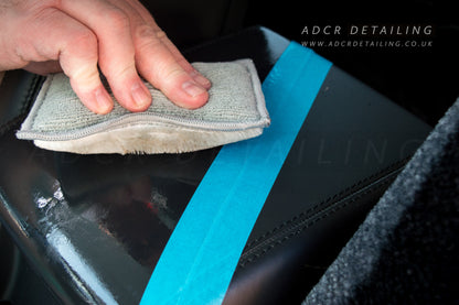 Detailing Interior Scrub Pad cleaning leather arm rest in a car. Restoring the matt clean leather look.