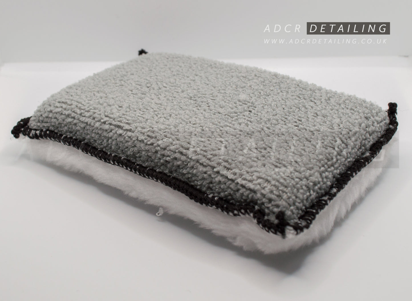 Microfibre cleaning pads with a sponge center, with a flat microfibre side and the other a soft, fluffy microfiber side.