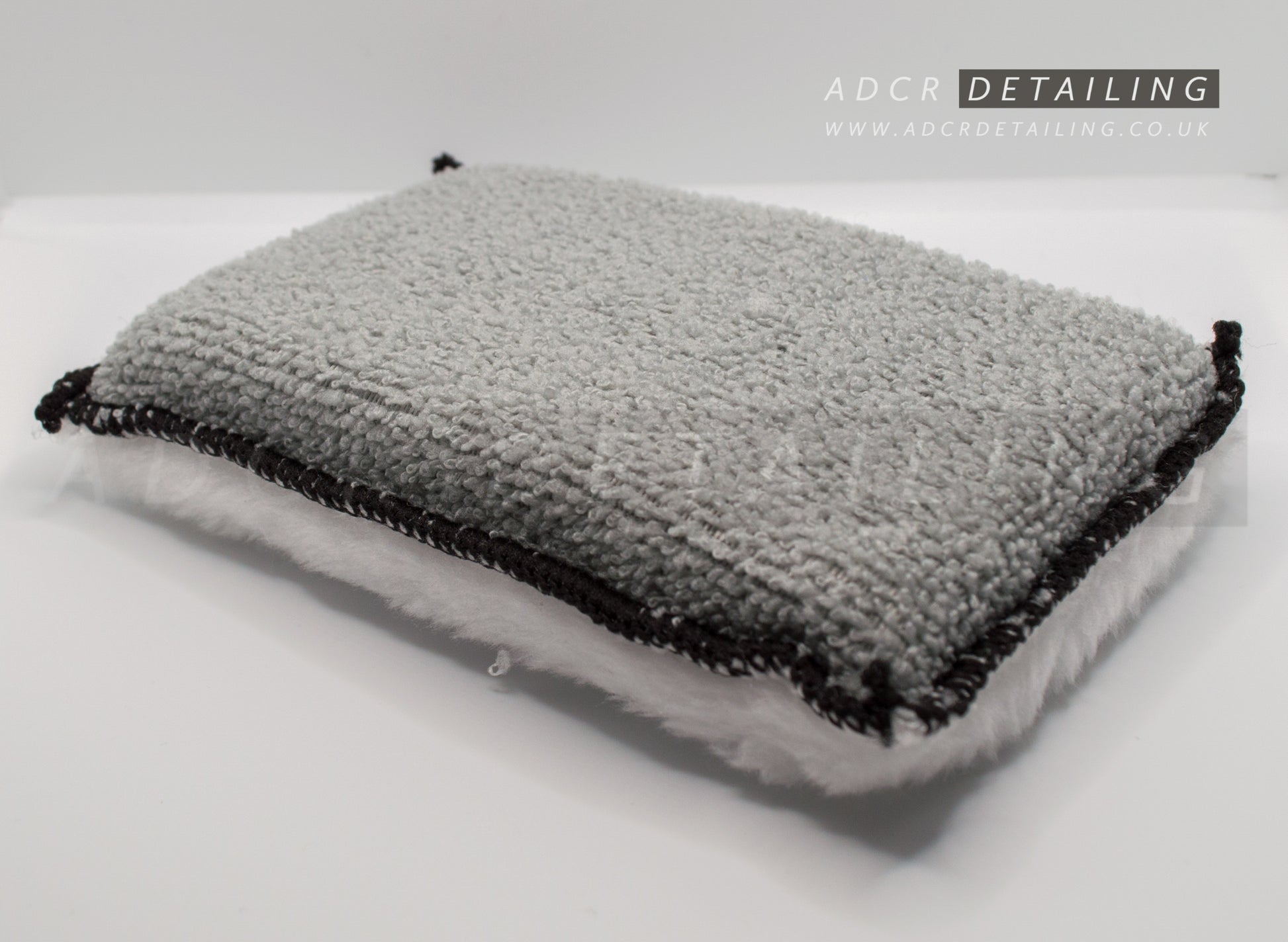 Microfibre cleaning pads with a sponge center, with a flat microfibre side and the other a soft, fluffy microfiber side.